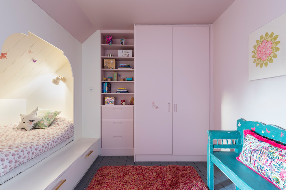 Design ideas for a contemporary children’s room for girls in London with pink walls.