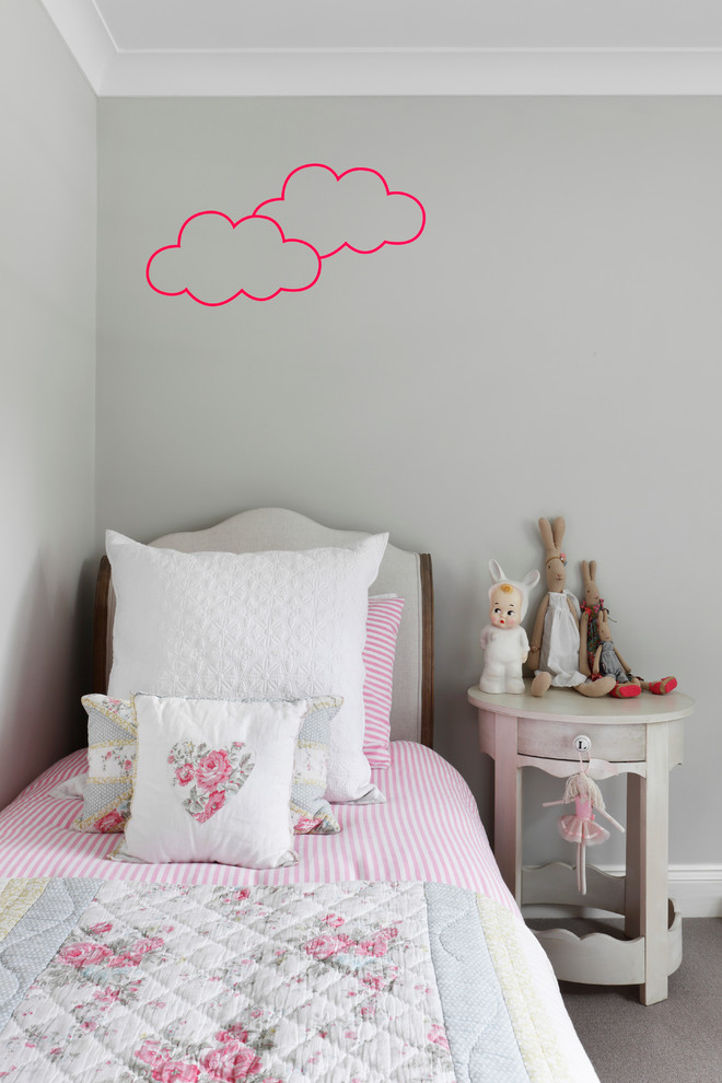 Photo of a small classic toddler’s room for girls in London with grey walls and carpet.