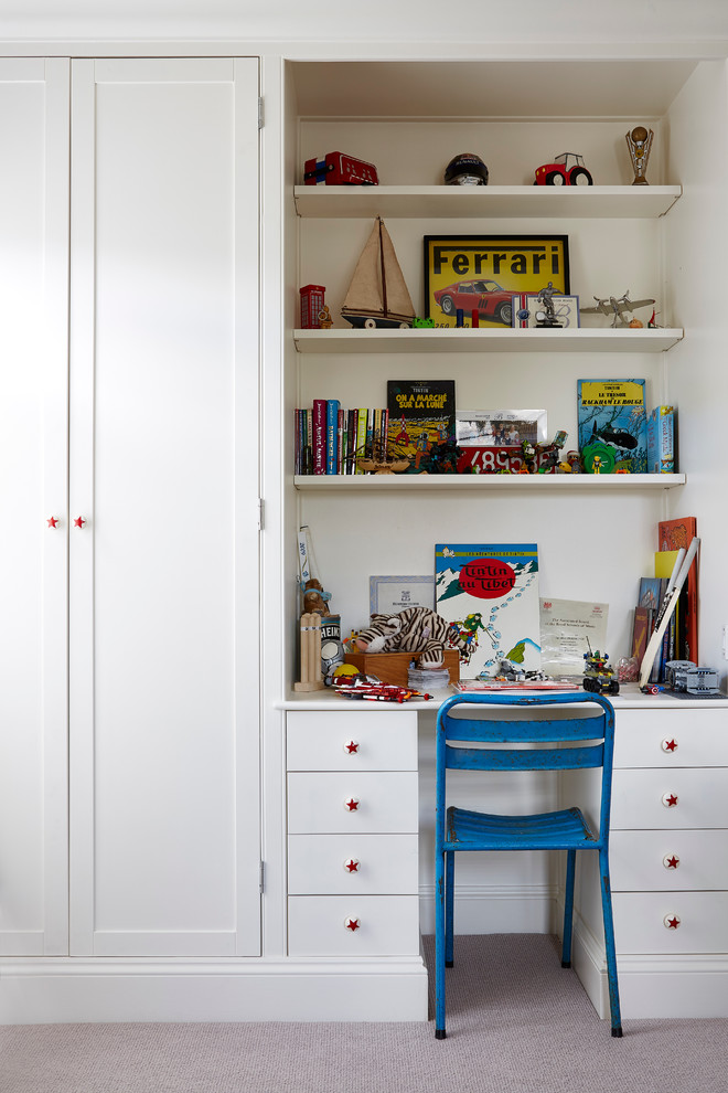 This is an example of a traditional kids' bedroom for boys in London with white walls and carpet.