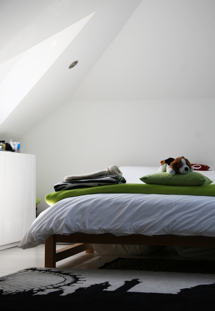 This is an example of a contemporary kids' bedroom in London with white walls.
