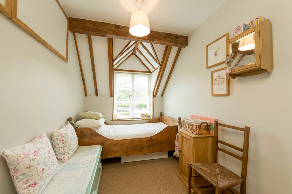 This is an example of a small country kids' bedroom in Kent with green walls, carpet and beige floors.