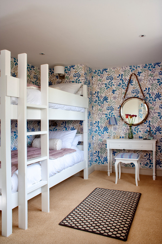 This is an example of a coastal children’s room for girls in Other with carpet, beige floors and multi-coloured walls.