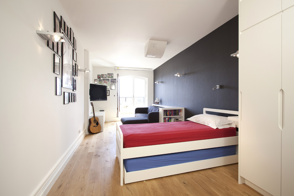 Inspiration för ett funkis könsneutralt tonårsrum kombinerat med sovrum, med ljust trägolv, beiget golv och flerfärgade väggar