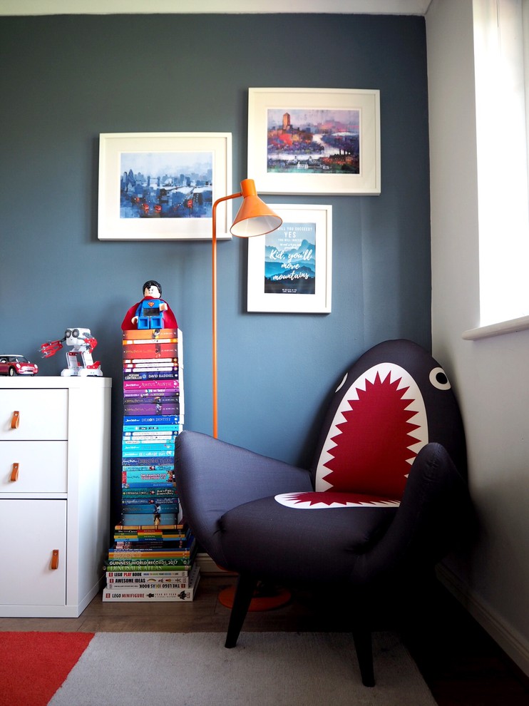 Design ideas for a small eclectic children’s room for boys in Surrey with blue walls, laminate floors and brown floors.