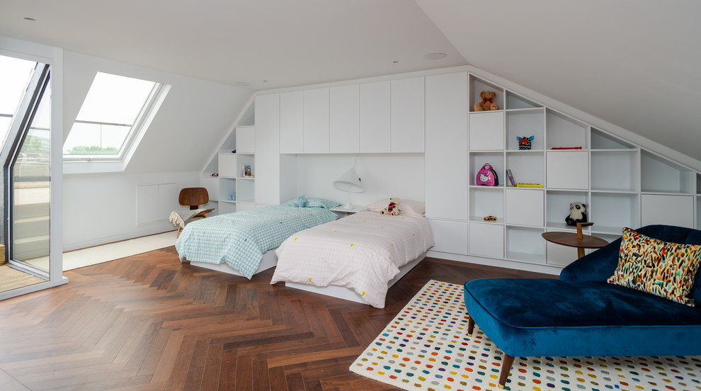 Inspiration for a contemporary gender neutral children’s room in London with white walls, medium hardwood flooring and brown floors.