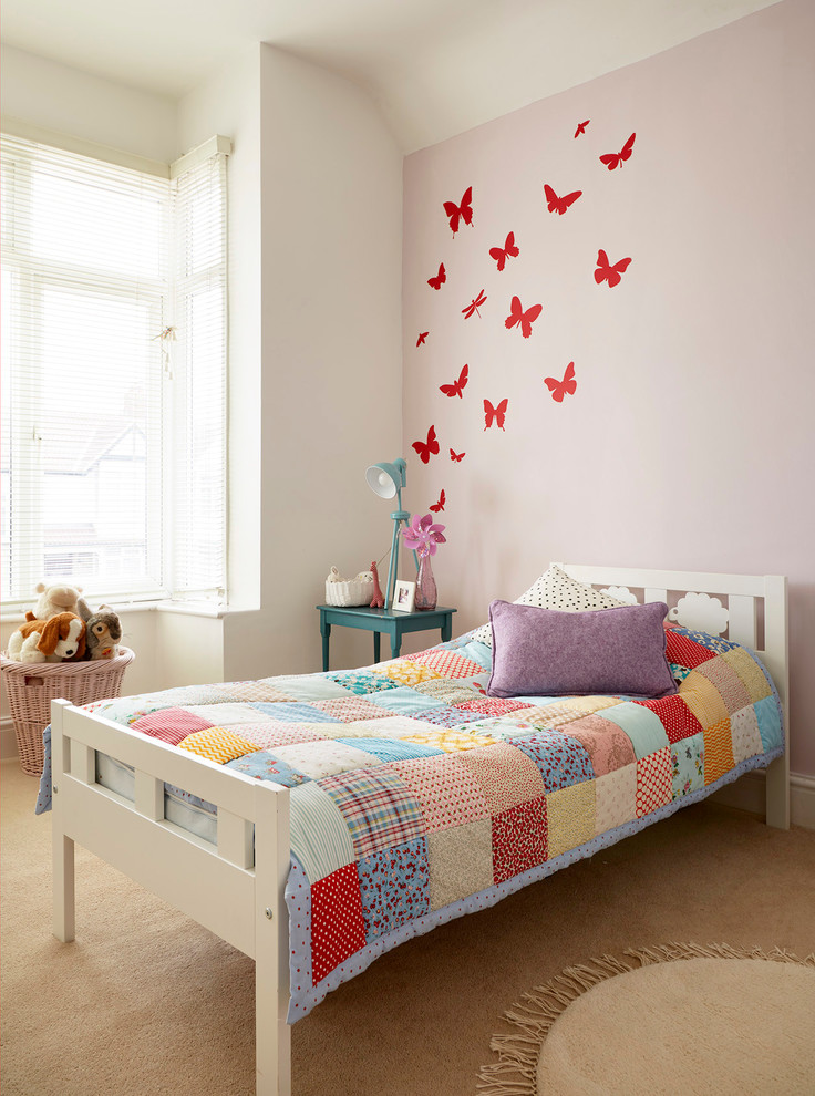 Photo of a traditional children’s room for girls in Wiltshire with carpet and multi-coloured walls.