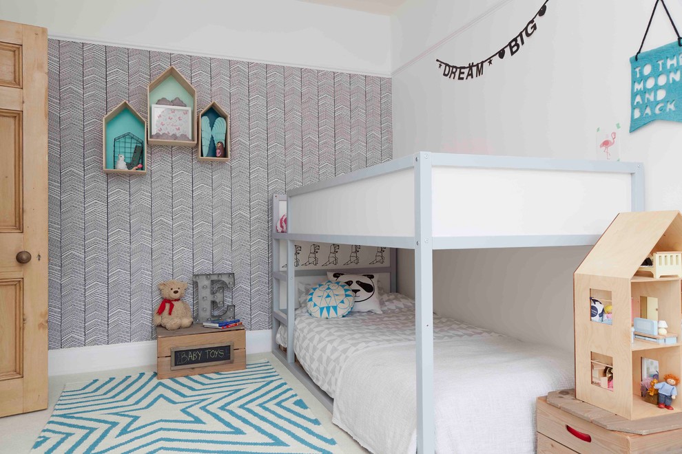 Photo of a medium sized contemporary gender neutral children’s room in London with white walls and carpet.