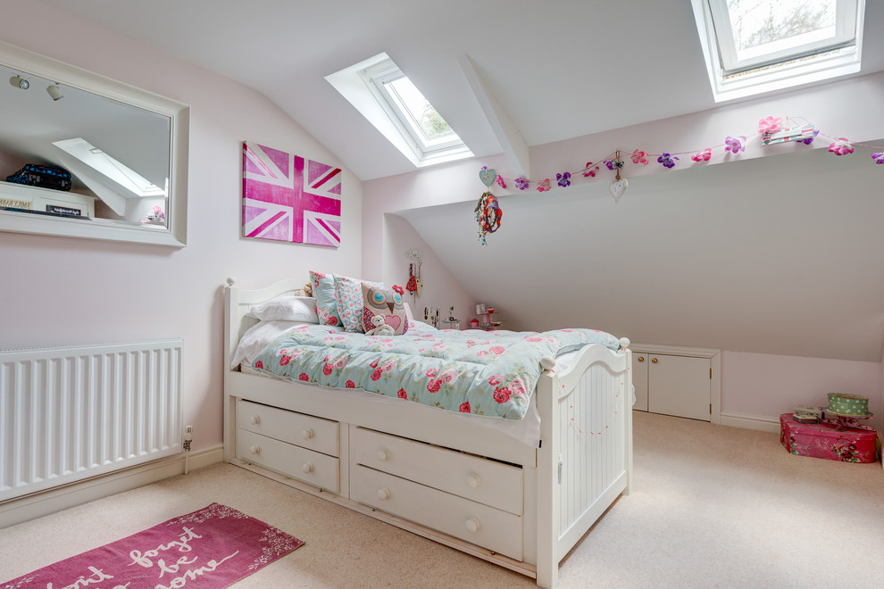 Small romantic children’s room for girls in Devon with white walls, carpet and beige floors.