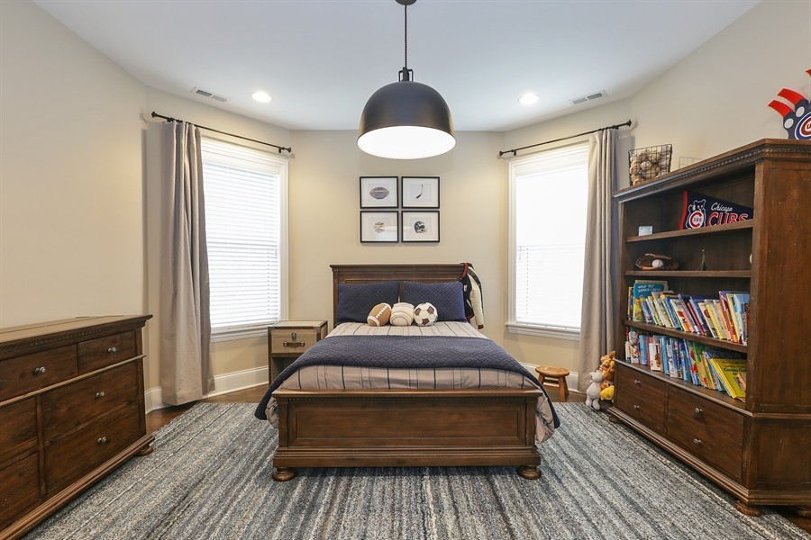 Inspiration for a large classic children’s room for boys in Chicago with beige walls, dark hardwood flooring and brown floors.