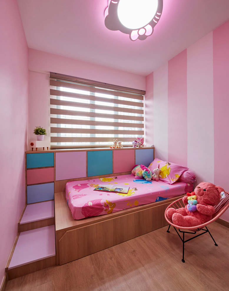 Design ideas for a medium sized scandi kids' bedroom in Singapore with pink walls and light hardwood flooring.