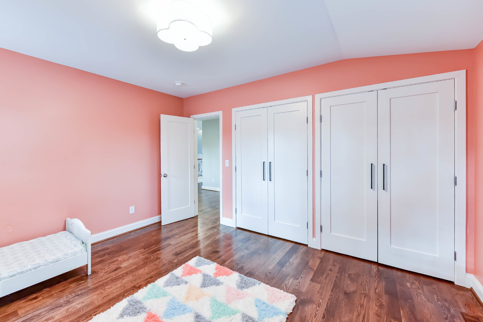 Ispirazione per una cameretta per bambini da 4 a 10 anni classica di medie dimensioni con pareti rosa, pavimento in legno massello medio e pavimento marrone