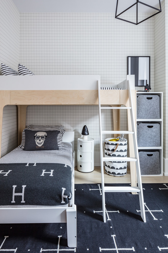 Scandi children’s room for boys in New York with multi-coloured walls and light hardwood flooring.
