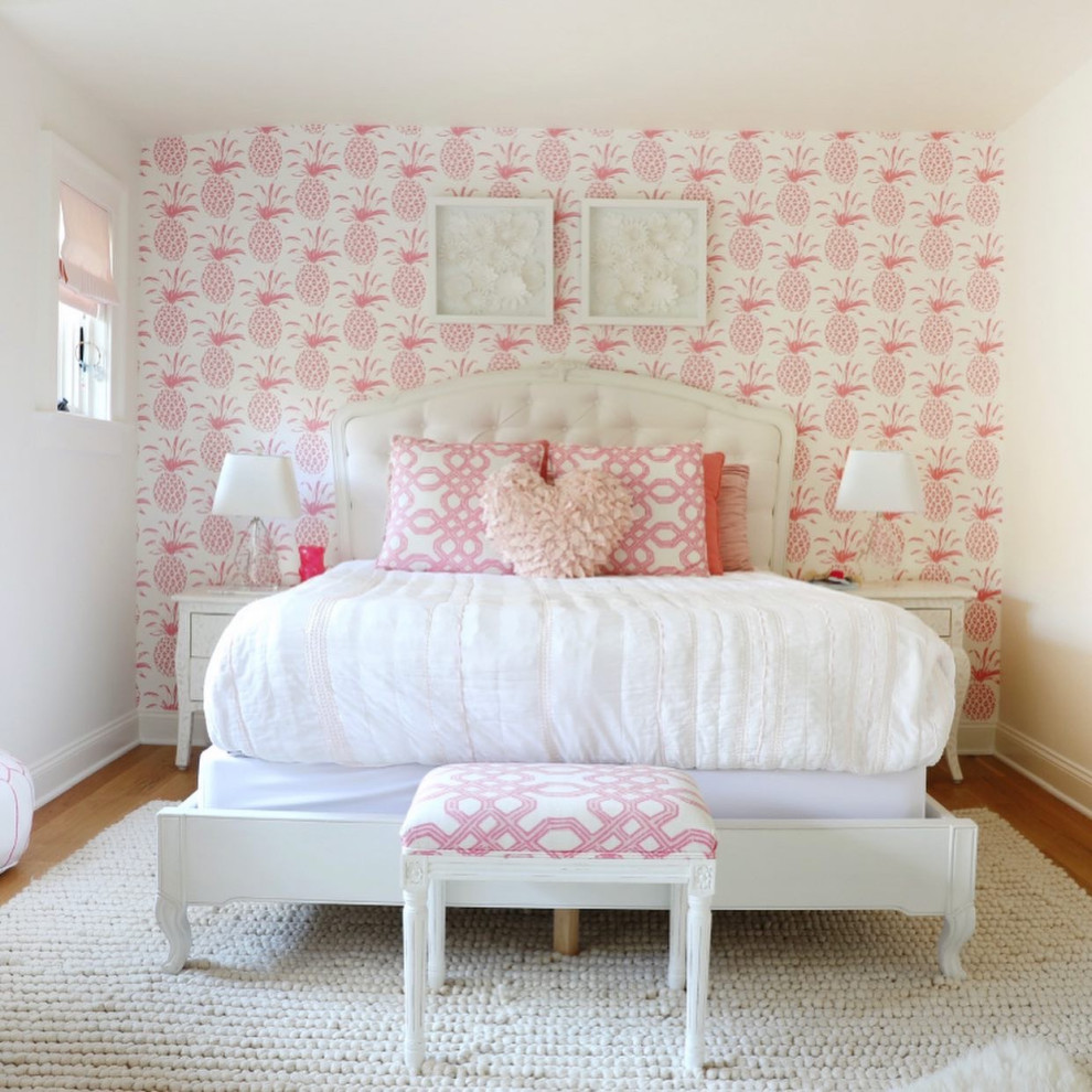 This is an example of a medium sized traditional children’s room for girls with white walls, light hardwood flooring, brown floors, a timber clad ceiling and wallpapered walls.