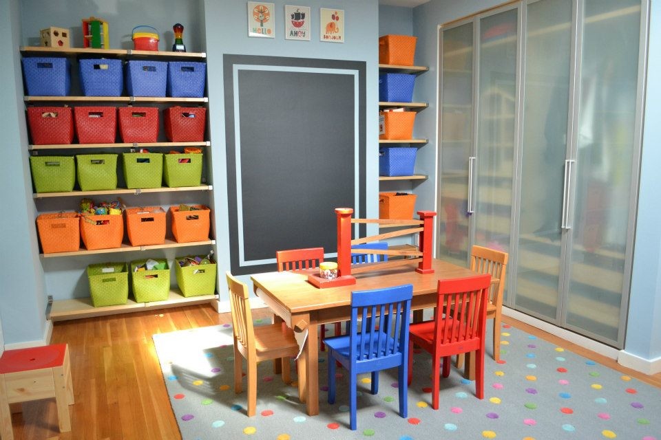 Kids' room - large traditional gender-neutral medium tone wood floor kids' room idea in Boston with blue walls