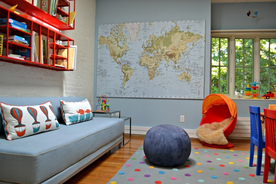 Large trendy gender-neutral light wood floor kids' room photo in Boston with multicolored walls