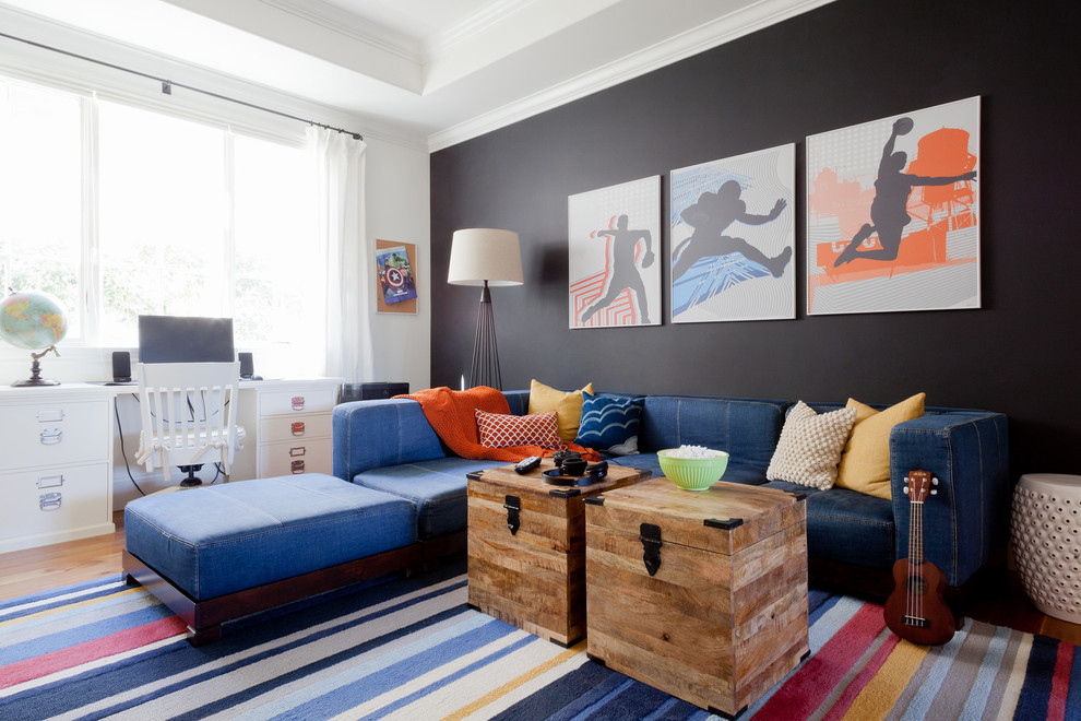 This is an example of a medium sized traditional gender neutral kids' bedroom in Los Angeles with medium hardwood flooring and multi-coloured walls.