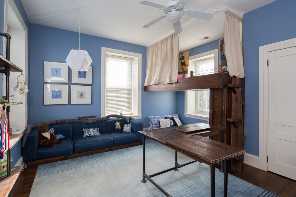 Aménagement d'une grande chambre d'enfant de 4 à 10 ans classique avec un mur bleu, un sol en bois brun et un sol marron.