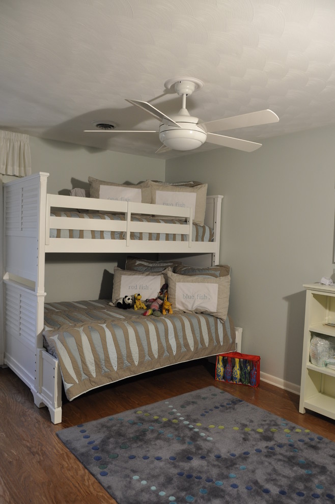 Immagine di una cameretta per bambini da 4 a 10 anni design di medie dimensioni con pareti grigie e pavimento in legno massello medio