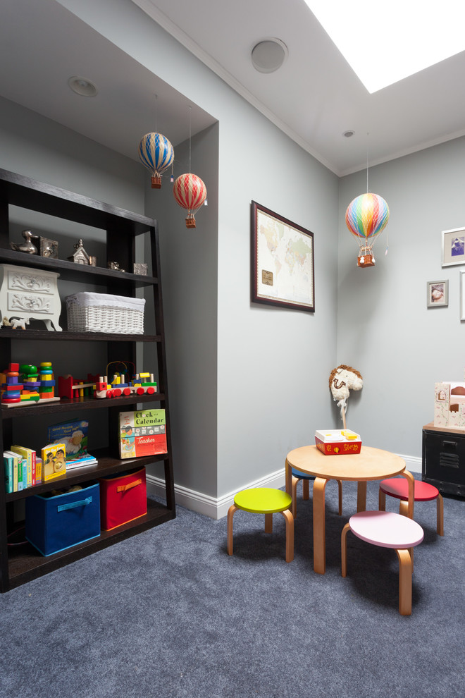 Small bohemian gender neutral kids' bedroom in New York with blue walls and carpet.
