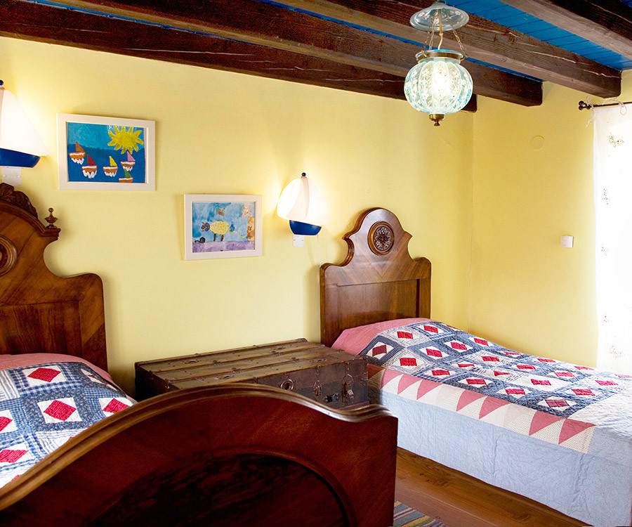 Ejemplo de dormitorio infantil mediterráneo con paredes amarillas y suelo de madera en tonos medios