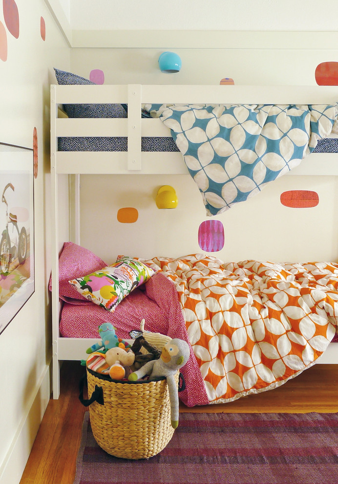 Bohemian gender neutral kids' bedroom in San Francisco with grey walls and medium hardwood flooring.