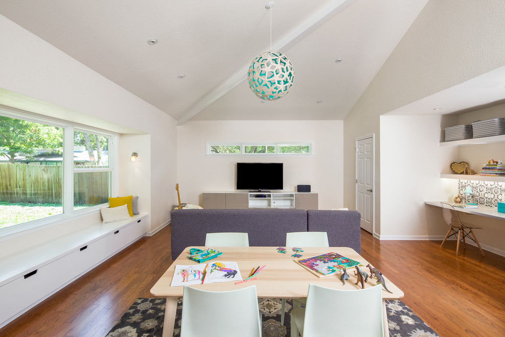 Example of a mid-sized trendy gender-neutral medium tone wood floor kids' room design in Austin with white walls