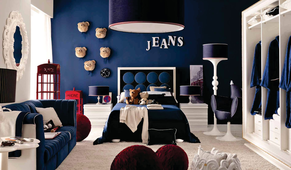 This is an example of a medium sized modern teen’s room for boys in London with blue walls and carpet.