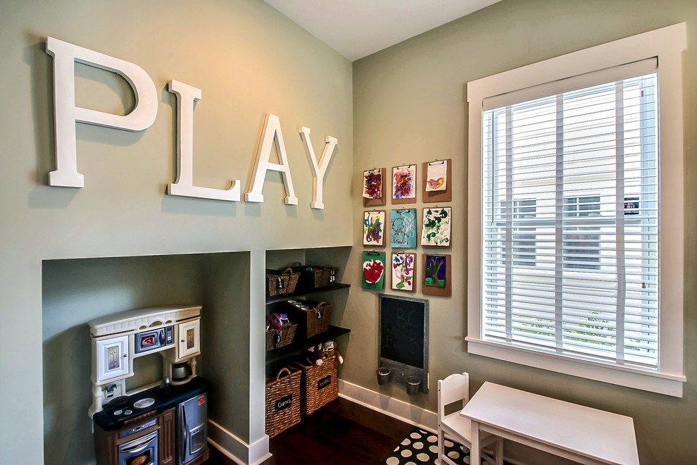 This is an example of a small traditional playroom for girls in Jacksonville with green walls and dark hardwood flooring.