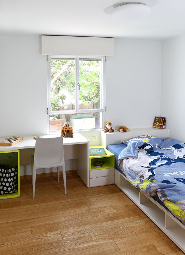 Kleines Modernes Jungszimmer mit Schlafplatz, weißer Wandfarbe und braunem Holzboden in Tel Aviv