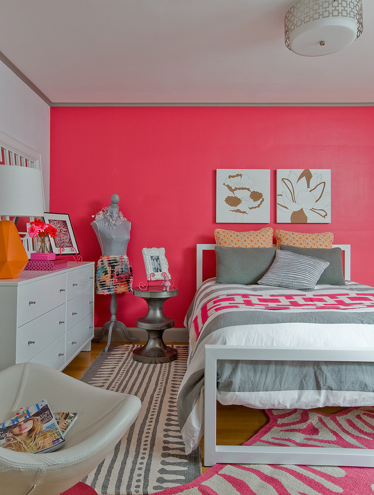 Medium sized bohemian teen’s room for girls in Boston with light hardwood flooring and pink walls.