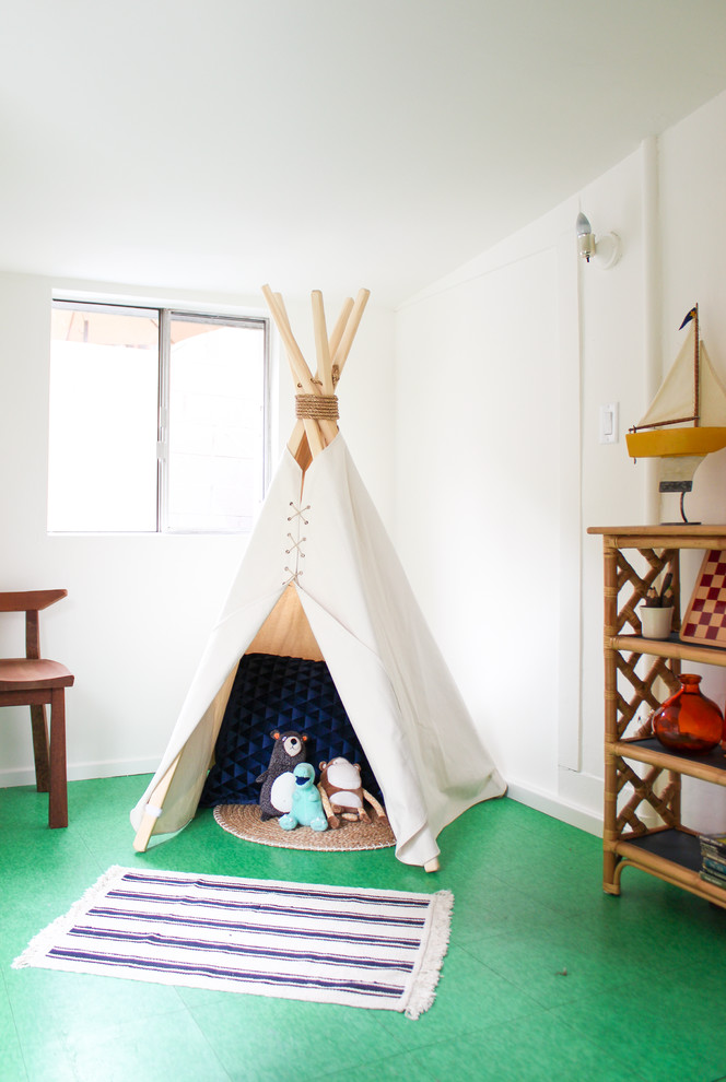 Medium sized bohemian gender neutral playroom in Los Angeles with white walls.