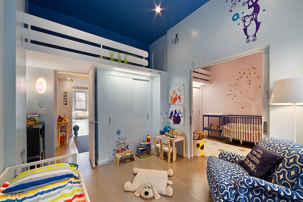 Photo of a large contemporary kids' bedroom in New York with multi-coloured walls and light hardwood flooring.