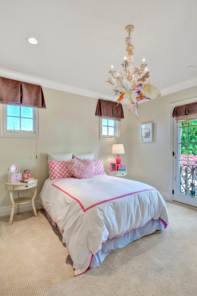 This is an example of a classic kids' bedroom for girls in Orange County with beige walls, carpet and beige floors.