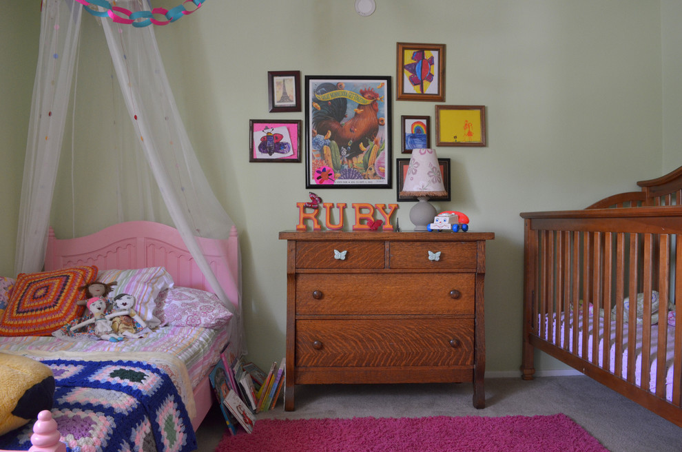 Bohemian toddler’s room for girls in Austin with carpet and grey walls.