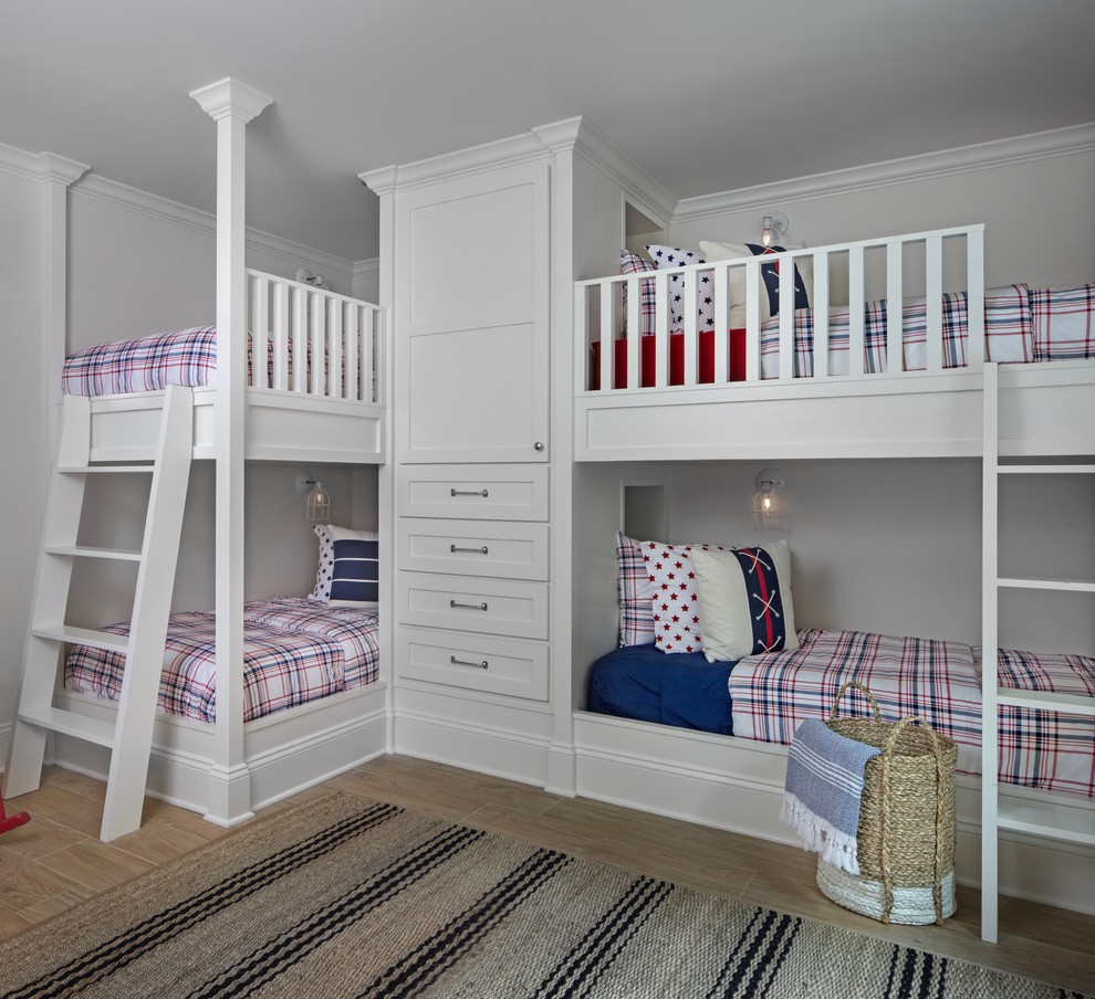 На фото: нейтральная детская в морском стиле с спальным местом, белыми стенами и светлым паркетным полом для ребенка от 4 до 10 лет, двоих детей