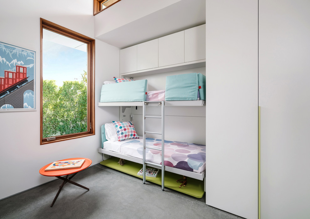 Idéer för funkis könsneutrala barnrum kombinerat med sovrum och för 4-10-åringar, med vita väggar, betonggolv och grått golv