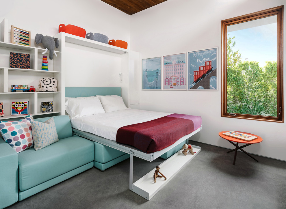 Esempio di una cameretta per bambini da 4 a 10 anni minimalista con pareti bianche, pavimento in cemento e pavimento grigio