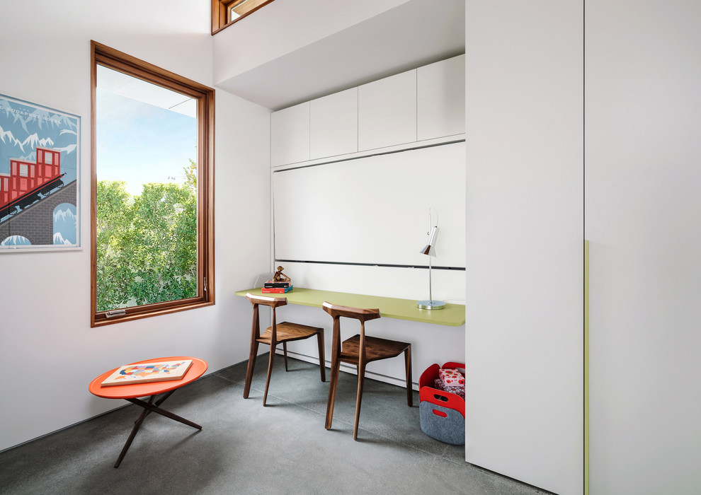 Photo of a contemporary gender neutral children’s room in Other with white walls, concrete flooring and grey floors.