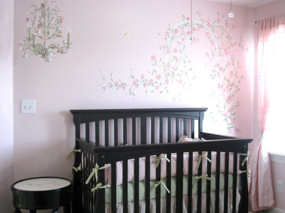 This is an example of a medium sized classic nursery for girls in Raleigh with pink walls and carpet.