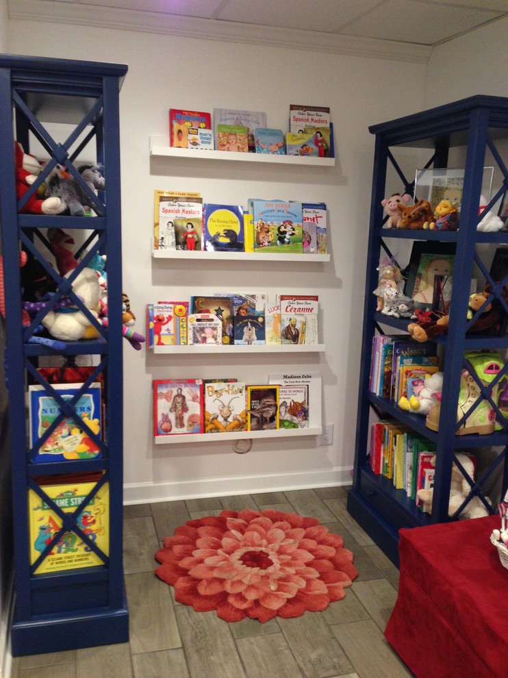 Example of a transitional gender-neutral ceramic tile kids' room design in Other with white walls