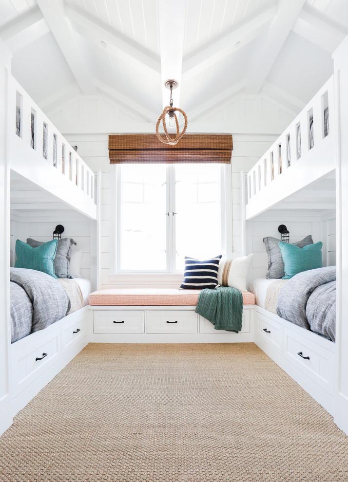 Medium sized nautical gender neutral kids' bedroom in Orange County with white walls and carpet.