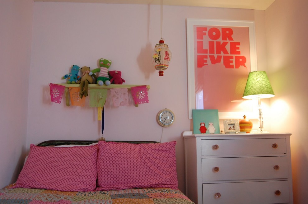 Example of an eclectic girl kids' room design in Los Angeles with white walls