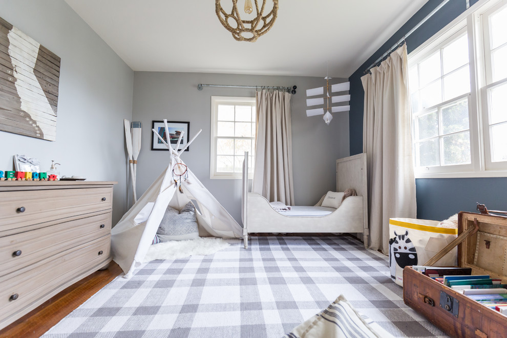 Inspiration for a medium tone wood floor and brown floor kids' bedroom remodel in San Diego with gray walls