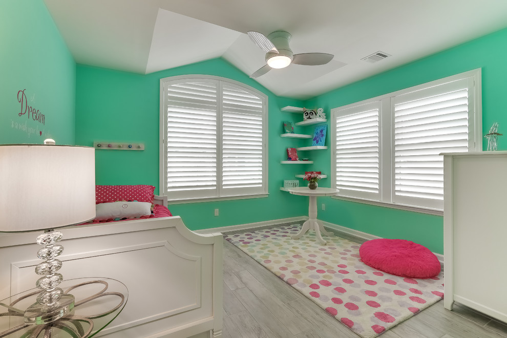 Inspiration for a medium sized coastal children’s room for girls in New York with green walls, porcelain flooring and beige floors.