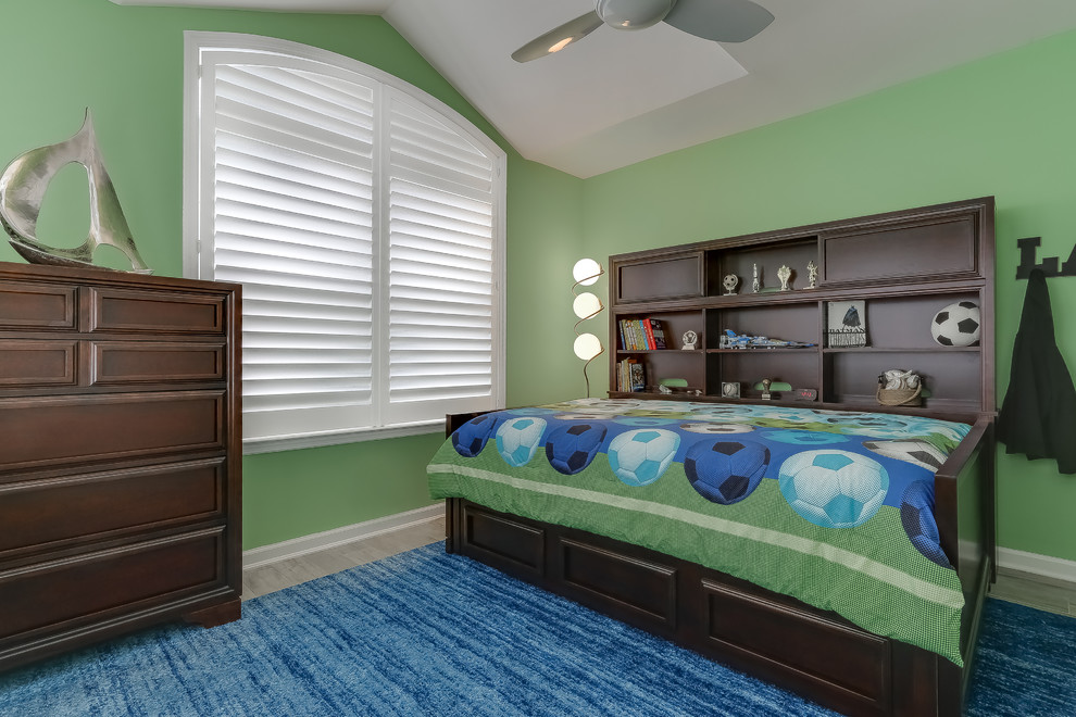 Photo of a medium sized nautical children’s room for boys in New York with green walls, porcelain flooring and beige floors.