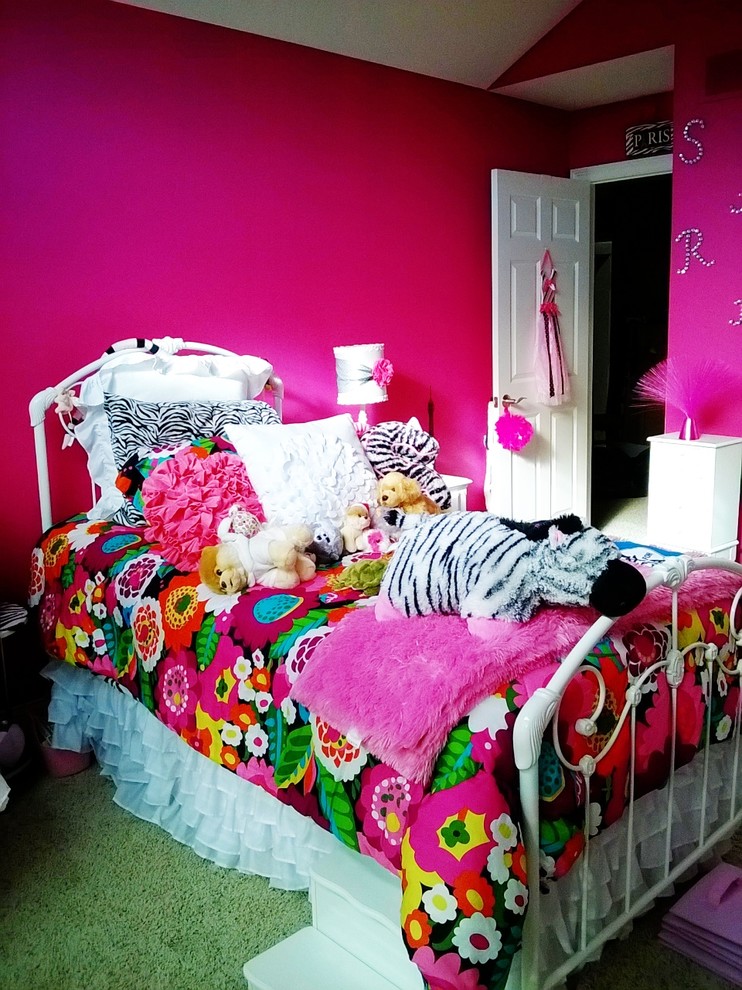 Example of an eclectic girl carpeted kids' room design in Grand Rapids with pink walls