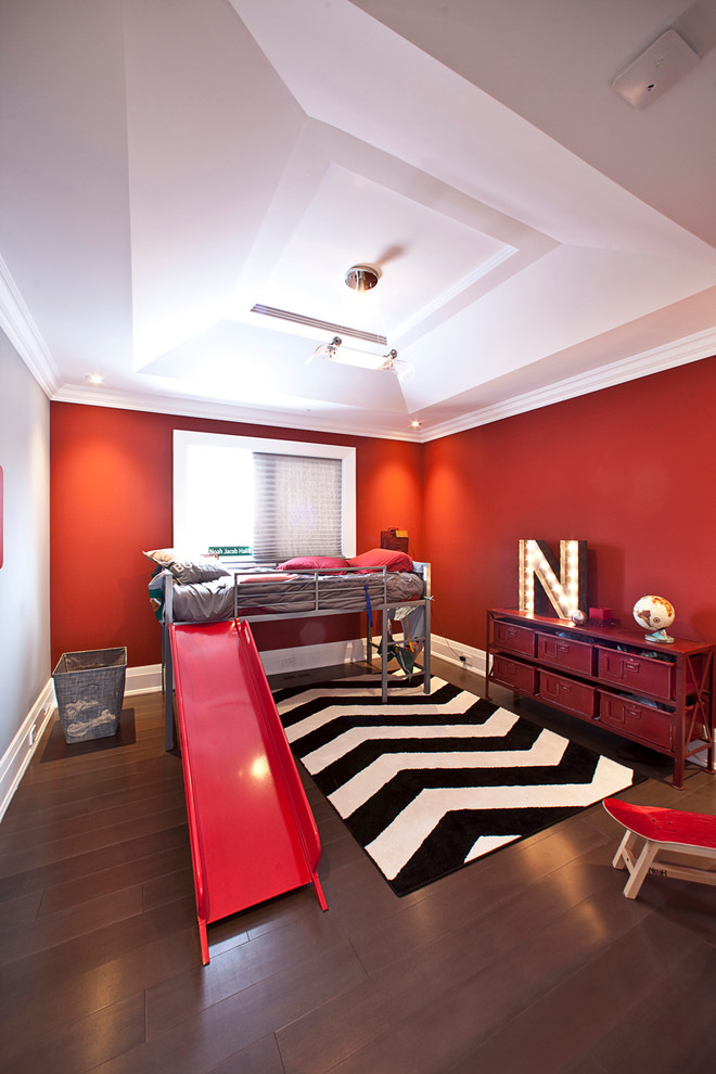 Réalisation d'une chambre d'enfant de 4 à 10 ans design avec un mur rouge, parquet foncé et un sol marron.