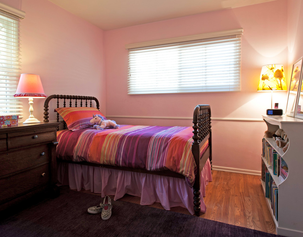 Mid-sized eclectic girl light wood floor kids' room photo in Los Angeles with pink walls