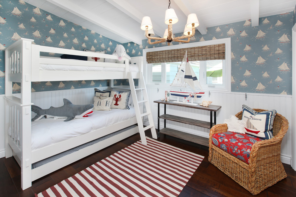 Example of an island style gender-neutral dark wood floor kids' room design in Orange County with multicolored walls