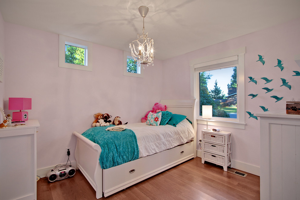 Inspiration for a mid-sized craftsman girl carpeted kids' bedroom remodel in Seattle with pink walls